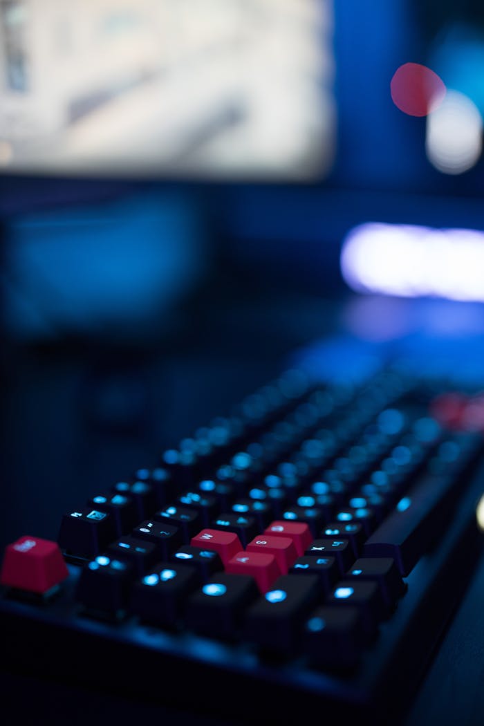 A focused shot of a gaming keyboard with illuminated keys, showcasing modern tech design.